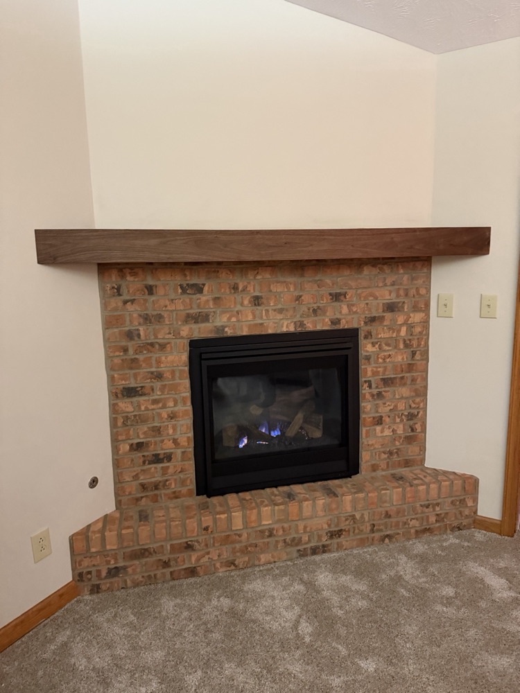 After: rebuilt brick fireplace with a handmade walnut mantel, Centerville, OH