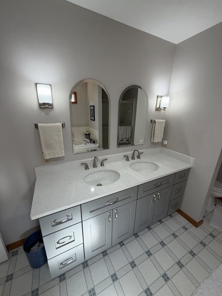 After: gray double vanity with quartz top and arched mirrors, Centerville, OH