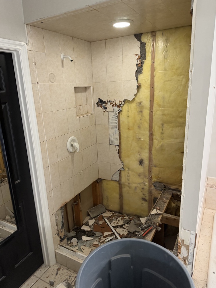 Old shower torn out down to the studs during demolition