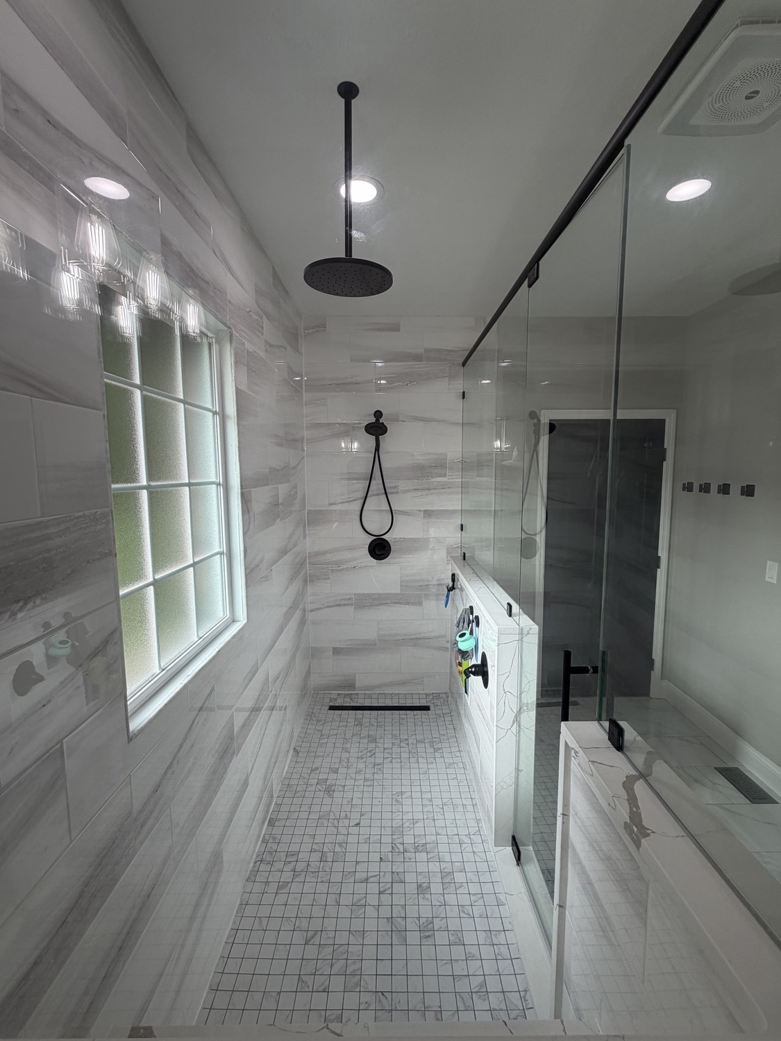 Curbless walk-in shower with rainfall head and matte black fixtures