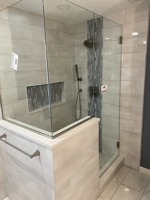 Walk-in shower with beige tiled walls