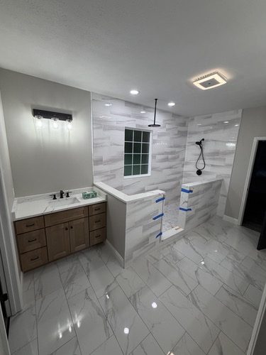 Master bathroom remodel with marble-look tile and walk-in shower