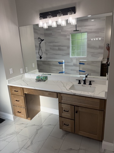 Vanity with makeup counter and matte black fixtures