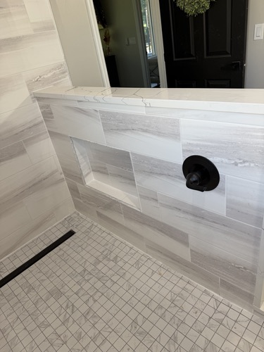 Tile pony wall and linear drain detail on a walk-in shower