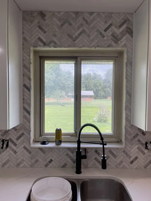 Kitchen sink with black faucet