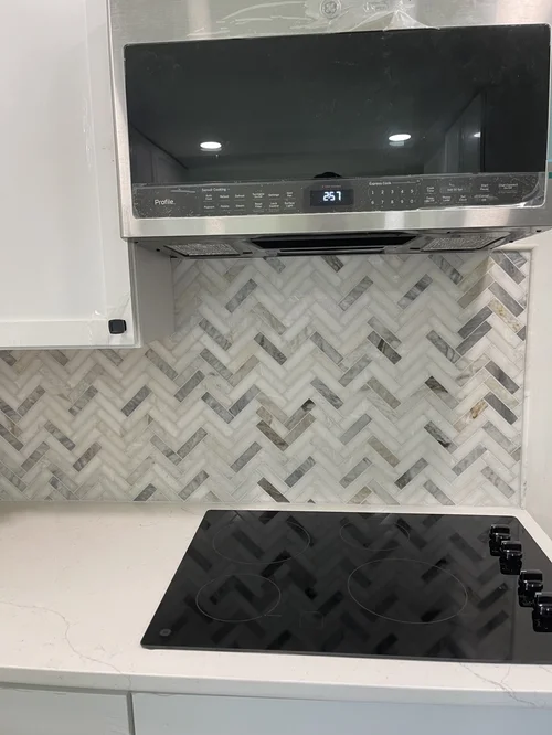 Kitchen stove with a black glass top and four burners