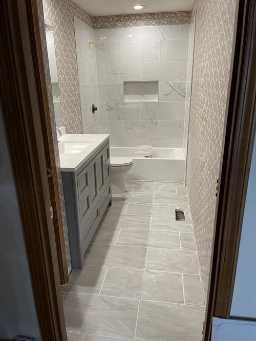Bathroom with light-colored marble tiles on the floor and wall, Springboro, OH