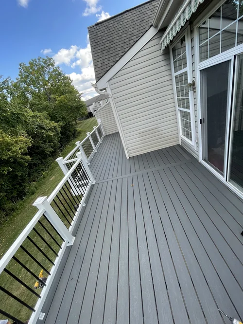 Spacious backyard deck with gray flooring