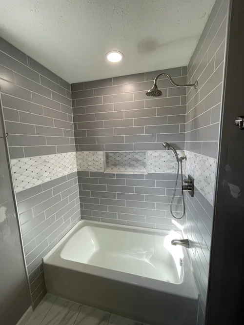 Bathroom shower with gray subway tiles