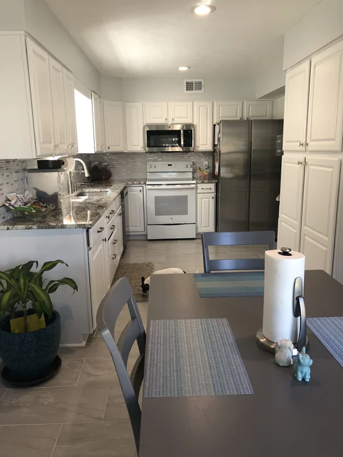 Kitchen with white cabinets and stainless appliances
