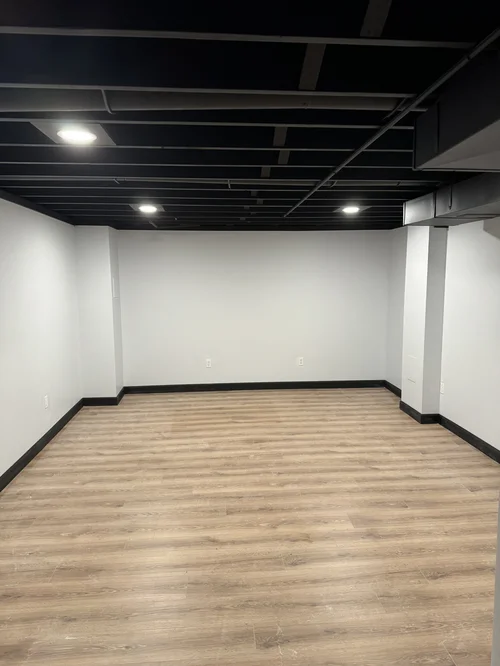 Finished room with light wood flooring