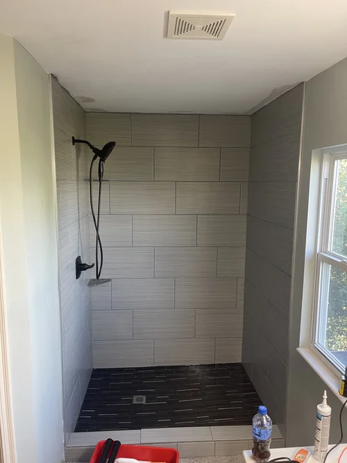 Empty walk-in shower with large gray tiles on the walls, Cincinnati, OH