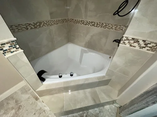 Bathroom corner with a tiled wall