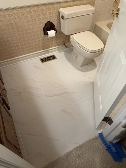 Small bathroom with beige patterned wallpaper