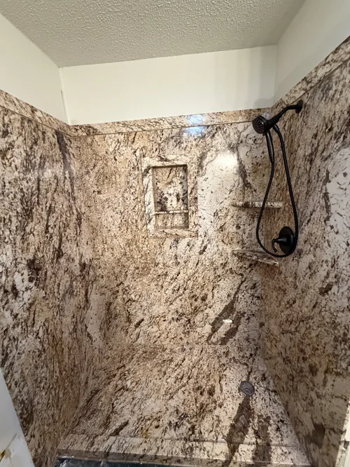 Shower with brown and beige marble walls and floor, West Alexandria, OH