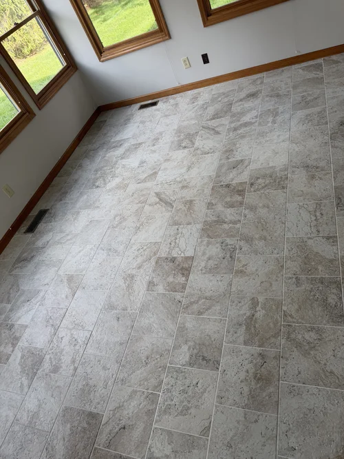 Empty room with tiled beige and gray floor