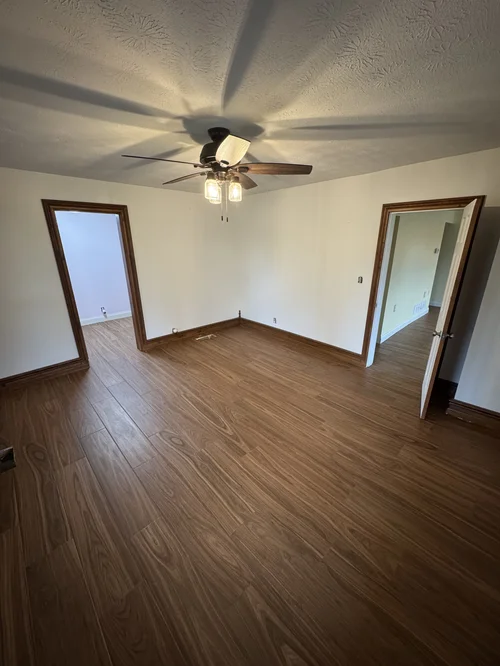 Room with new wood flooring and fresh paint