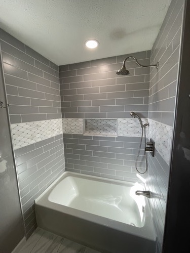 Gray subway tile shower with rainfall head and accent band, Mason, OH