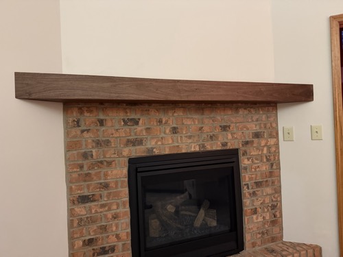 Handmade walnut mantel on a rebuilt brick fireplace, Centerville, OH
