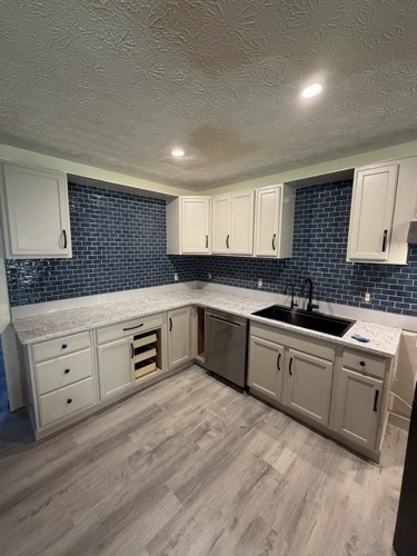 Kitchen with navy glass subway tile backsplash and white cabinets, Dayton, OH