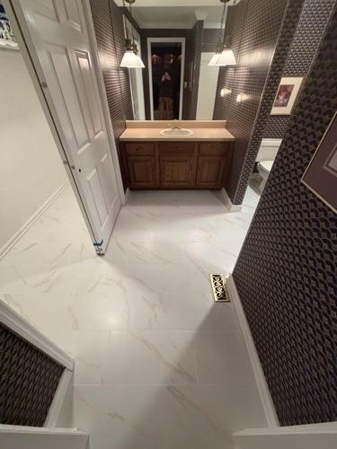 Marble-look tile floor with new trim and vanity, Bellbrook, OH