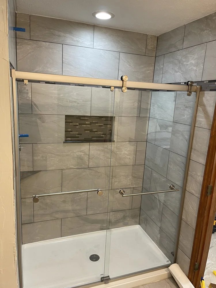 Walk-in shower with gray stone tile